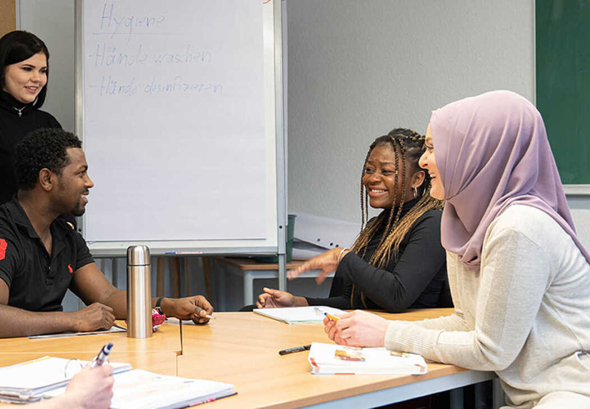 Fünf Personen sind um einen Besprechungstisch versammelt